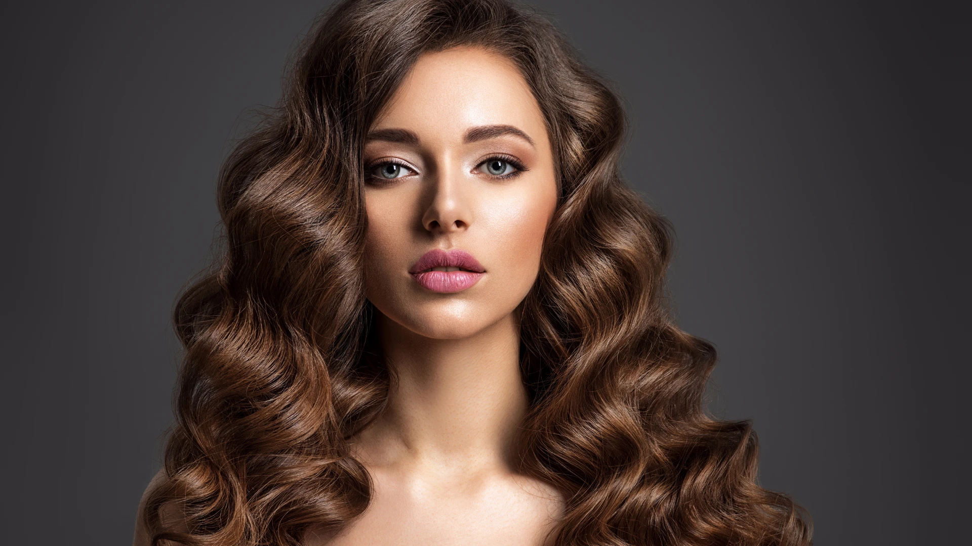 Woman with thick, voluminous hair after hair restoration treatment at Park City Medesthetix